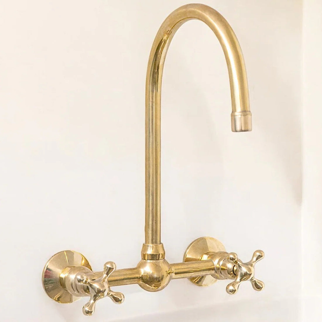Unlacquered brass wall mount bridge faucet with gooseneck spout and ball center
