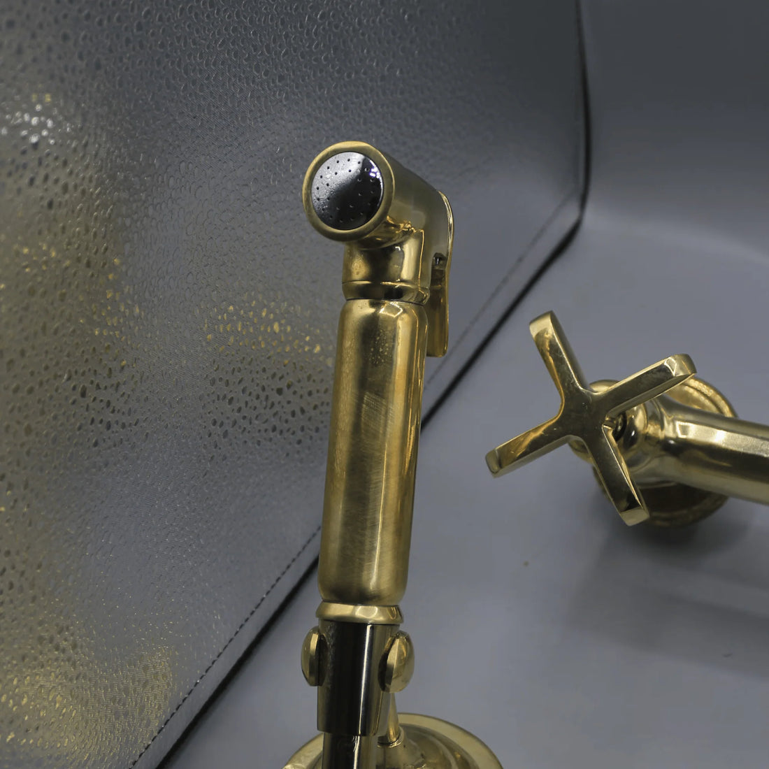 Unlacquered brass wall mount kitchen faucet with sprayer, 8 inch spread
